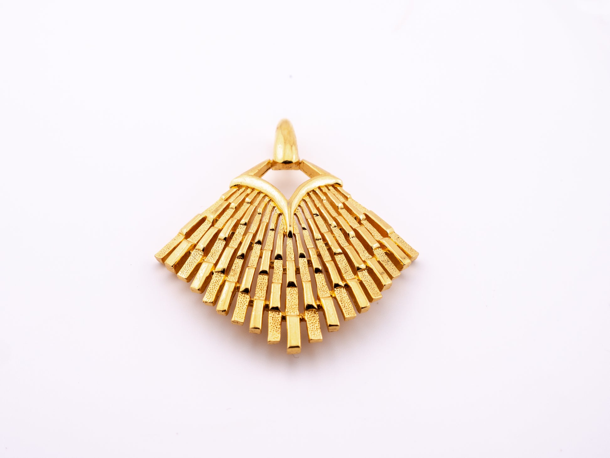 Vintage Crown Trifari gold tone fan pendant with graduated brushed bars radiating from a V-shaped yoke