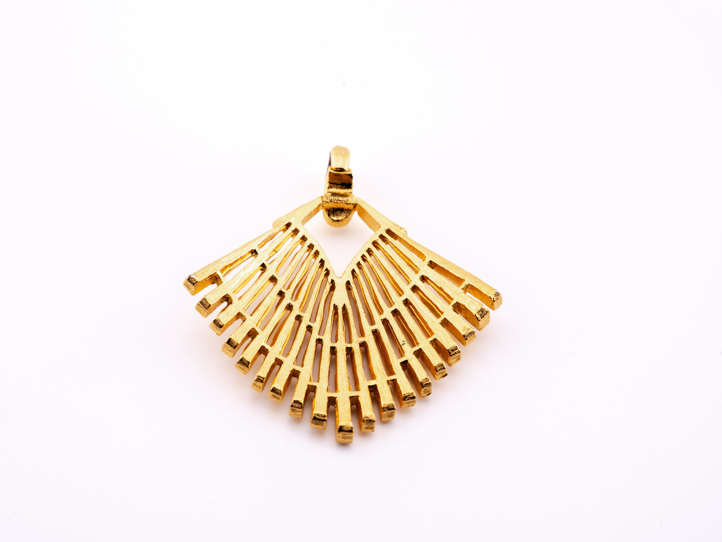 Reverse of Crown Trifari fan pendant showing openwork construction and hinged bail