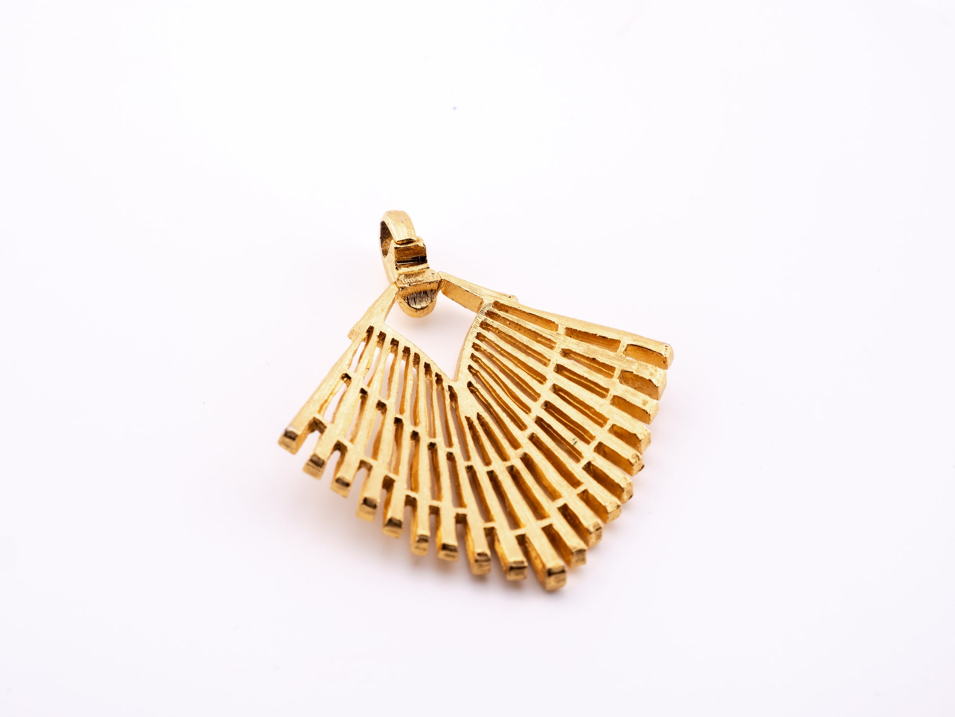 Angled view of Crown Trifari fan pendant showing depth of the openwork bars